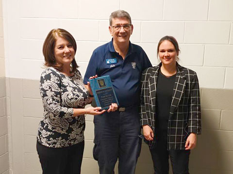 John Barrett (President) presenting an Optimist Community Partner plaque to the Food 4 Life team.